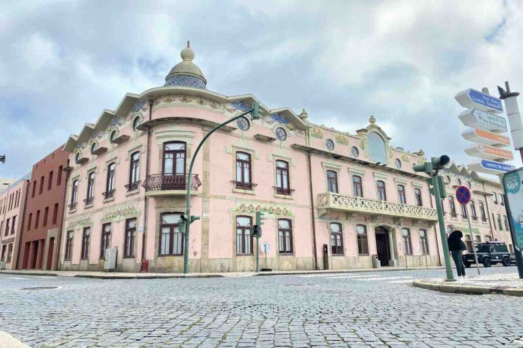 Foto de um edifício rosa com um relógio
